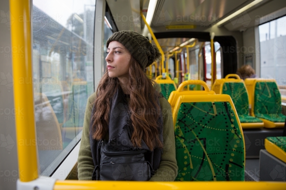 Young Woman Sits Alone on the Melbourne Tram - Australian Stock Image