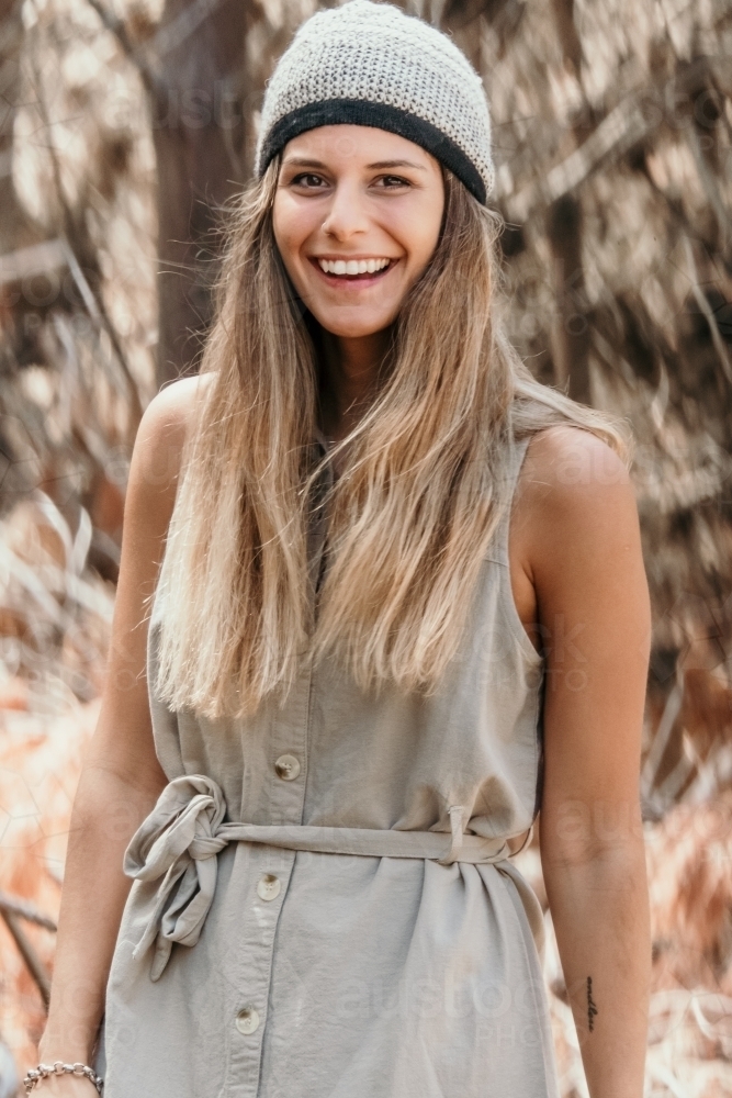Young woman smiling outdoors. - Australian Stock Image