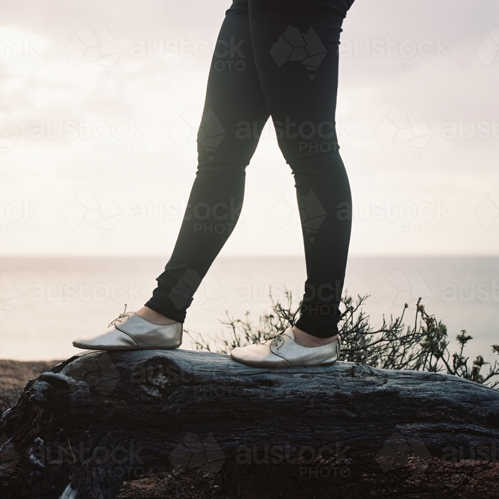 Young Woman Standing on Log - Australian Stock Image