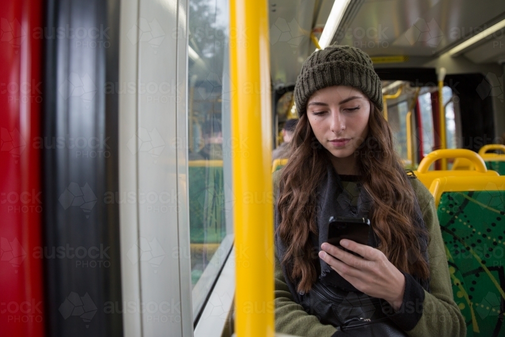 Young Woman Texting on the Tram - Australian Stock Image