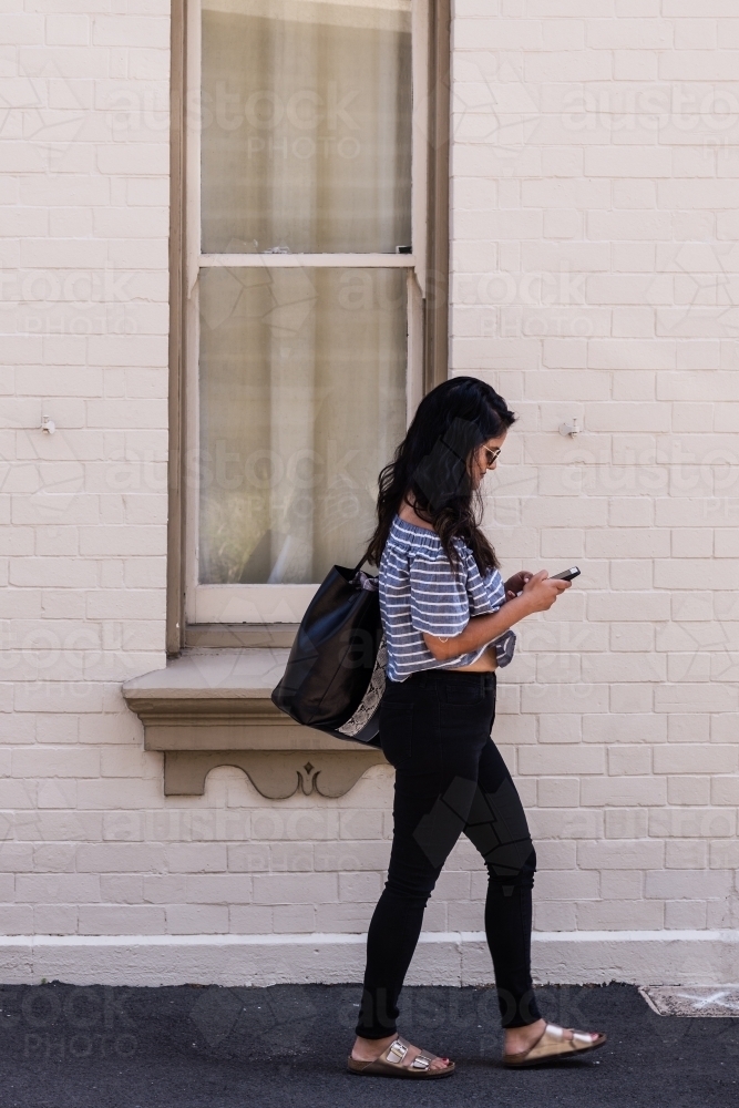young woman walking in the city - Australian Stock Image