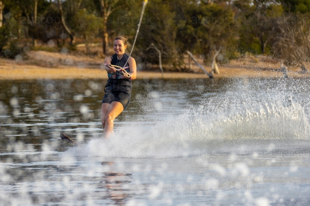 young woman waterskiing on inland Lake Towerrinning - Australian Stock Image