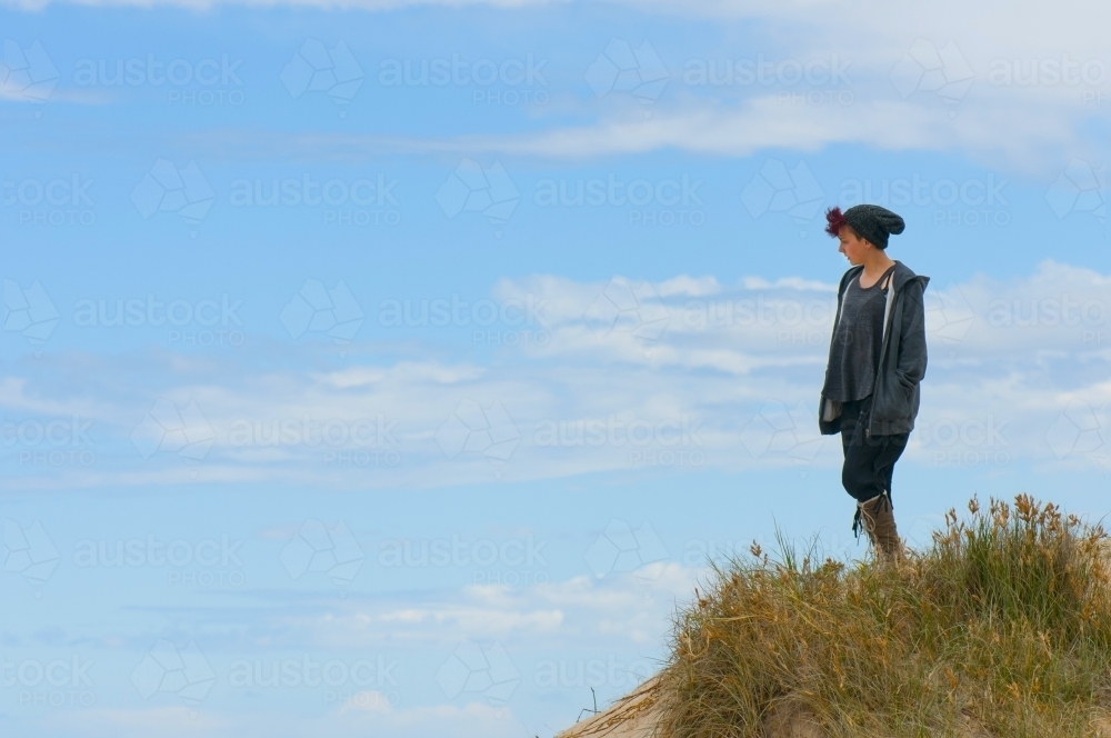 Young woman wearing a beanie on a sand dune - Australian Stock Image
