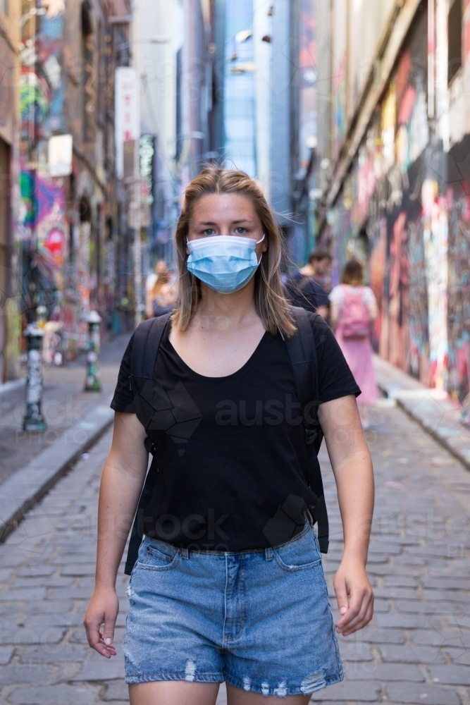 Young Woman Wearing a Face Mask Exploring Melbourne Lanes - Australian Stock Image