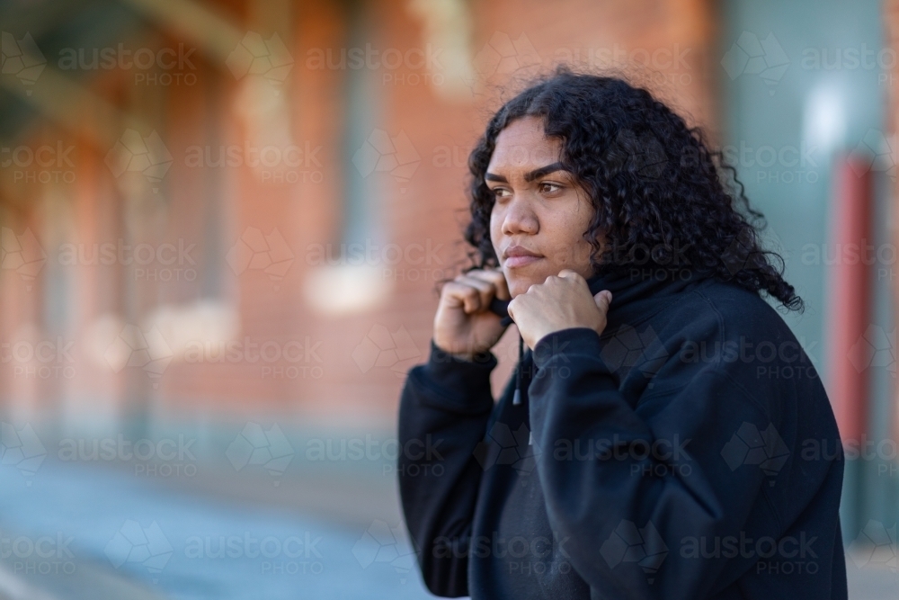 young woman wearing black in strong stance - Australian Stock Image
