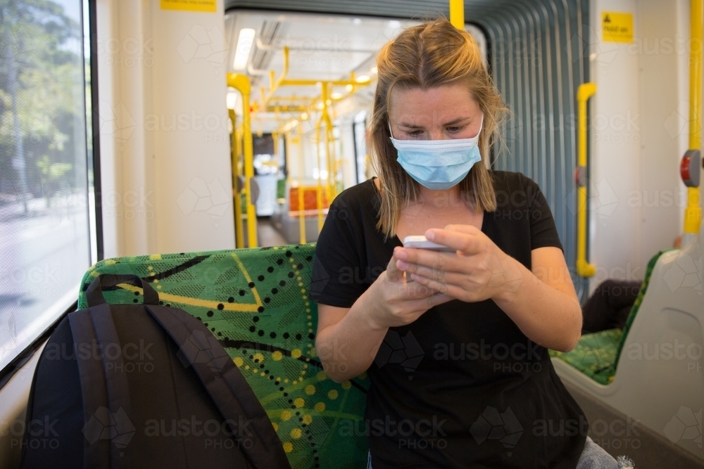 Young Woman Wearing Face Mask on Tram - Australian Stock Image