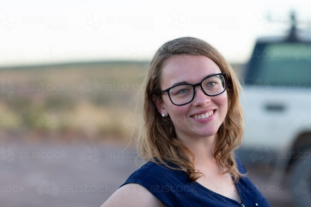 Young woman wearing glasses outdoors - Australian Stock Image