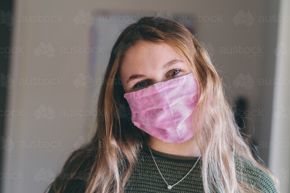young woman wearing homemade mask - Australian Stock Image