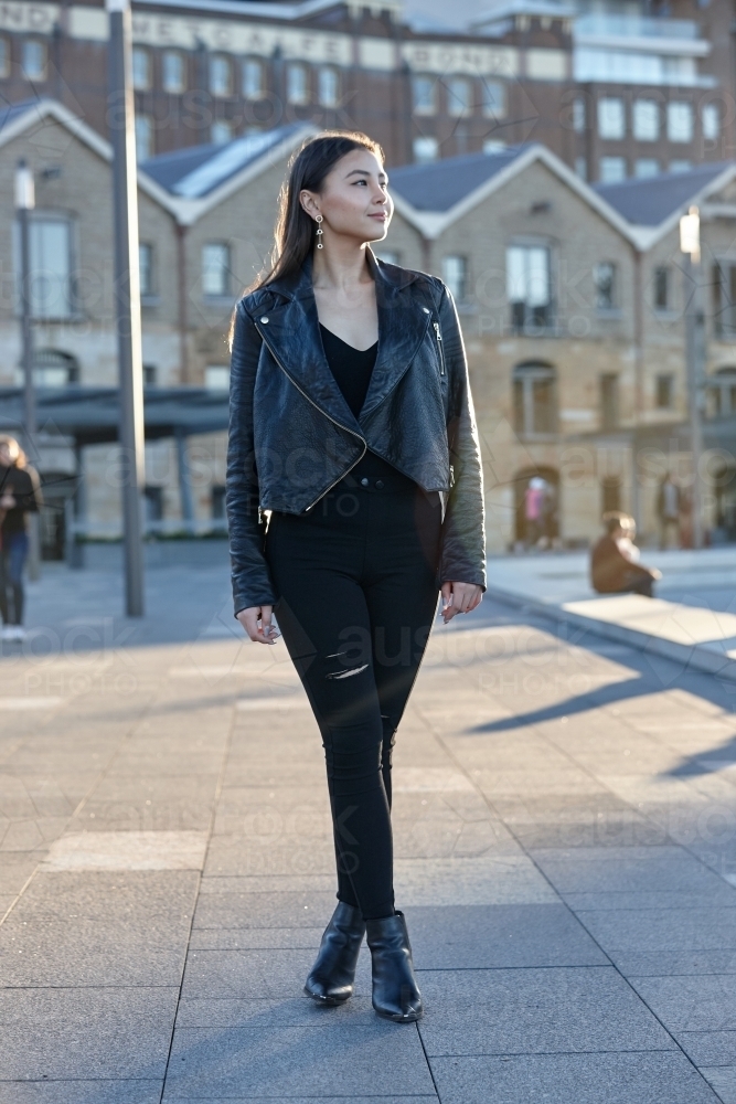 Young woman wearing leather jacket - Australian Stock Image