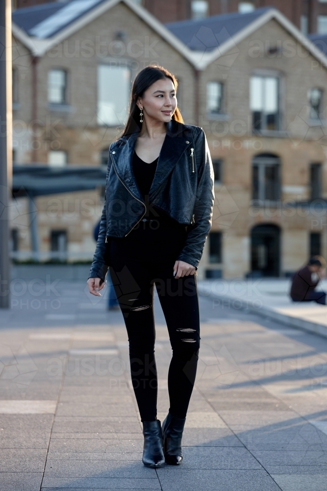 Young woman wearing leather jacket - Australian Stock Image