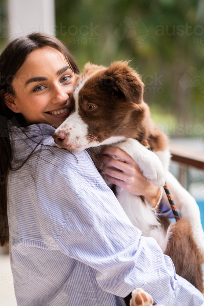 young woman with border collie puppy - Australian Stock Image