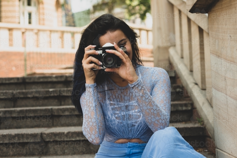 young woman with film camera - Australian Stock Image