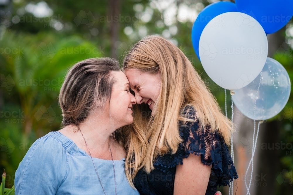 young woman with her mum at her birthday party - Australian Stock Image