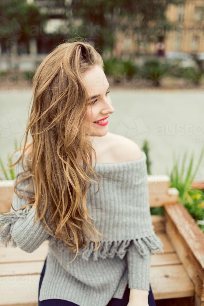 Young woman with long hair smiling and posing - Australian Stock Image