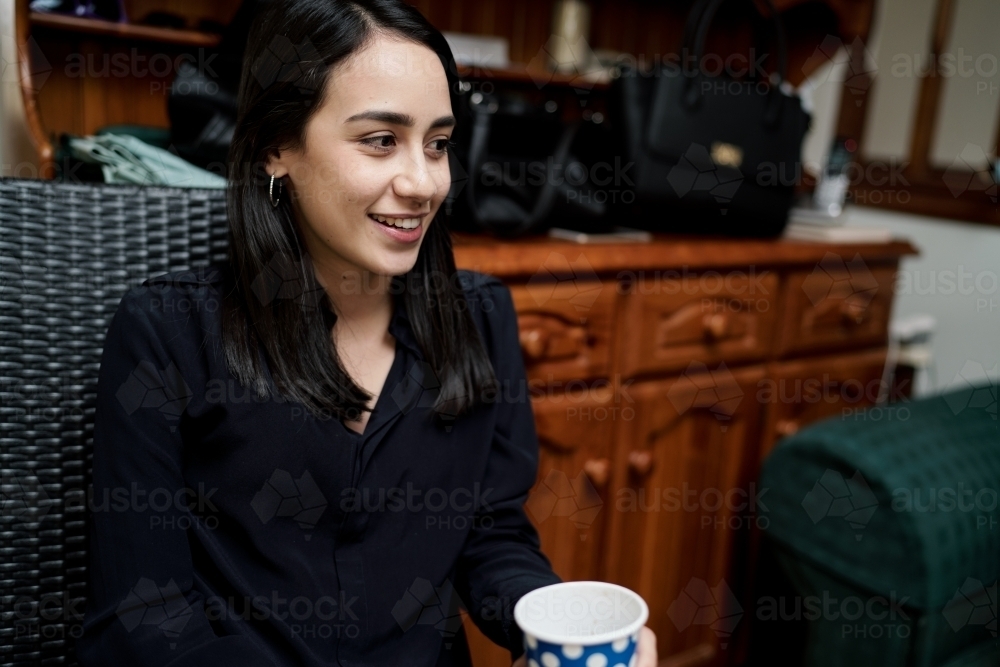 Young Woman with Straight Dark Hair and Black Shirt - Australian Stock Image
