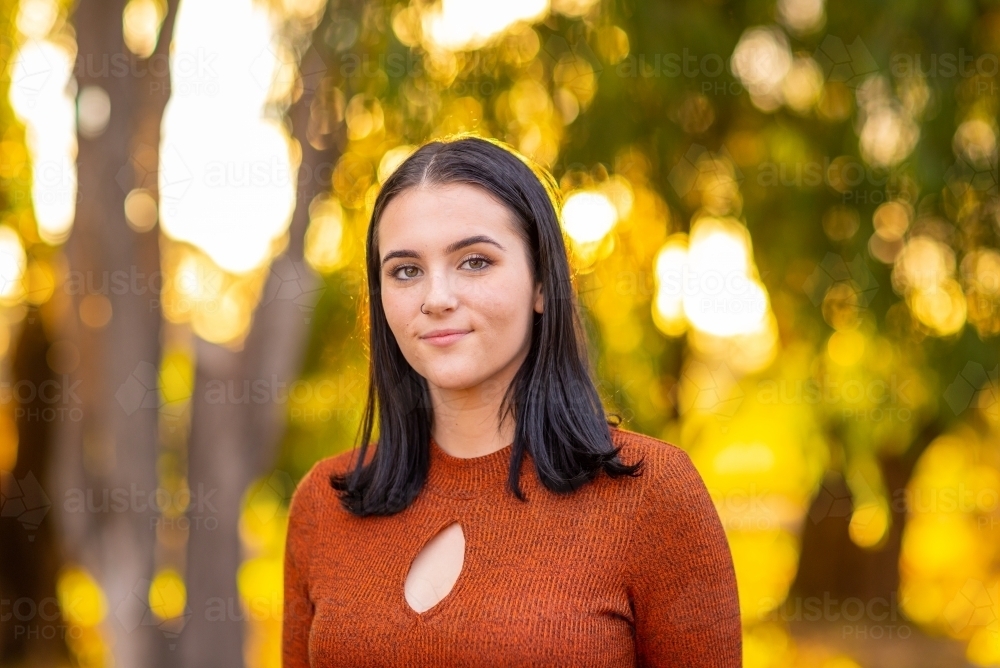 young woman with straight dark hair looking cheesed off - Australian Stock Image