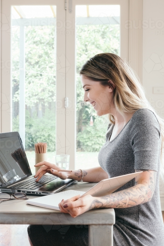 Young woman working or studying at home on a laptop - Australian Stock Image