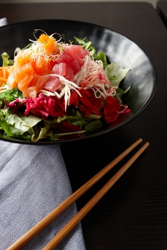 Sashimi salad in black bowl - Australian Stock Image