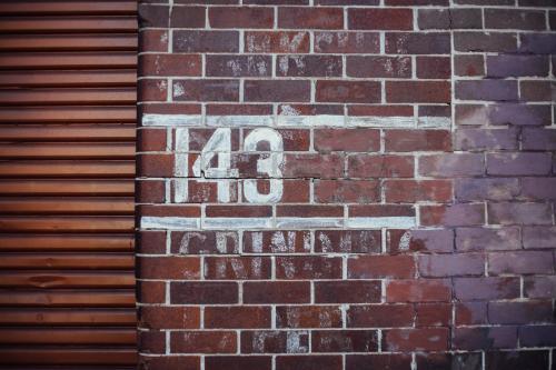 143 painted on brick wall - Australian Stock Image