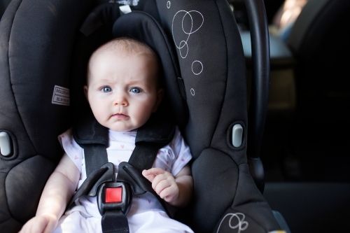 4 month old baby sitting in rear-facing car seat