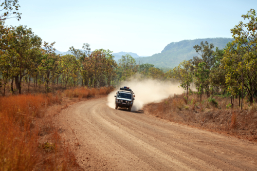 4 x 4 driving on dusty gravel road - Australian Stock Image