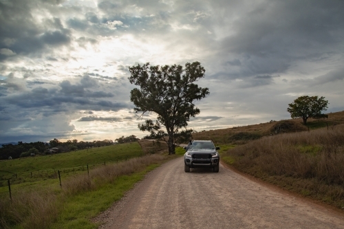 4x4 vehicle driving on dirt country road - Australian Stock Image