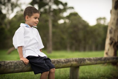 5 year old mixed race boy wearing his school uniform on his first day of school - Australian Stock Image