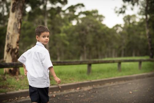 5 year old mixed race boy wearing his school uniform on his first day of school - Australian Stock Image
