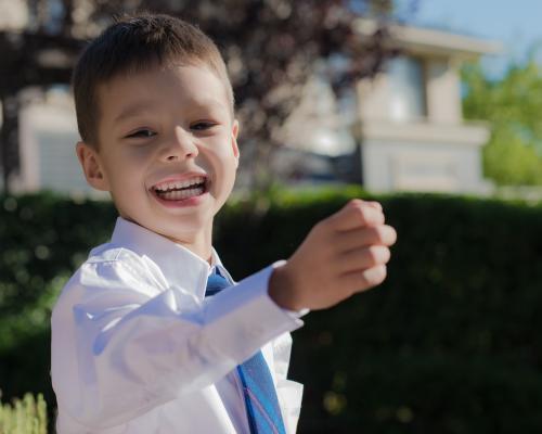 5 year old mixed race boy wearing his school uniform on his first day of school - Australian Stock Image