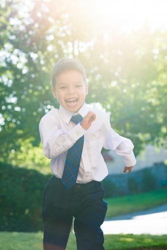 5 year old mixed race boy wearing his school uniform on his first day of school - Australian Stock Image