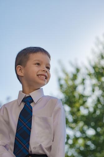 5 year old mixed race boy wearing his school uniform on his first day of school - Australian Stock Image