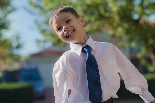 5 year old mixed race boy wearing his school uniform on his first day of school - Australian Stock Image