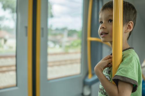 6 year old mixed race boy rides on a Sydney city train - Australian Stock Image