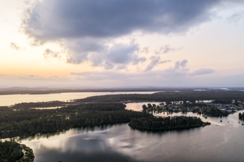 A aerial view of sunset over the river and small islands at Tuncurry - Australian Stock Image