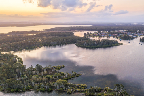 A aerial view of sunset over the river and small islands at Tuncurry - Australian Stock Image