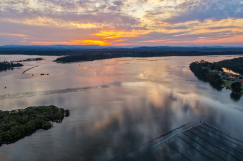 A aerial view of sunset over the river and small islands at Tuncurry - Australian Stock Image