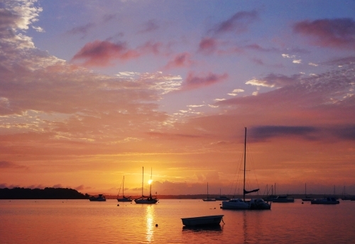 A beautiful sunrise over the boats moored in Moreton bay