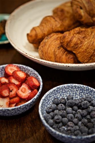 A breakfast selection of croissants, strawberries and blueberries