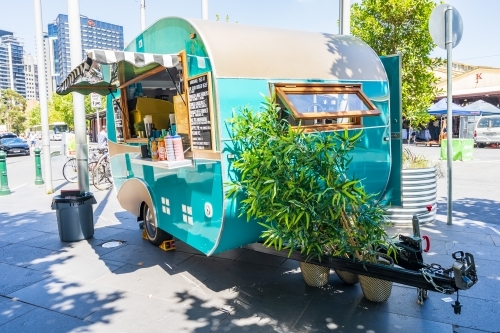 A brightly painted vintage caravan set up as a coffee van - Australian Stock Image