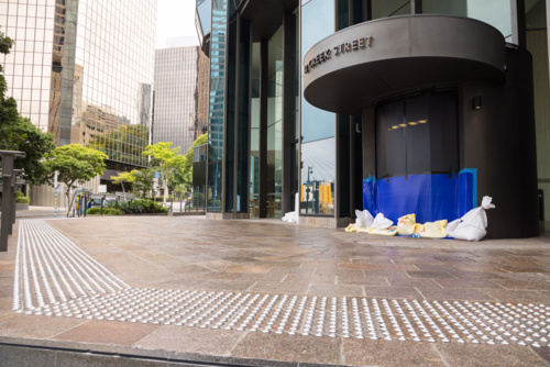 A building entrance is sandbagged and sealed in preparation for tropical cyclone Alfred in Brisbane - Australian Stock Image