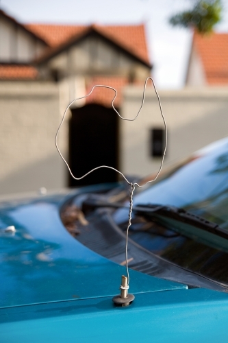 A car antenna made out of a coat hanger and shaped like a map of Australia