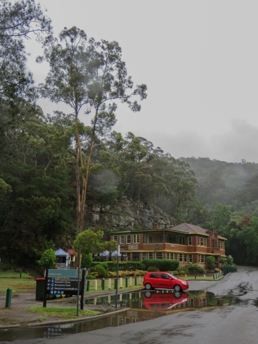 A car sits in king-tidal water on a misty morning - Australian Stock Image