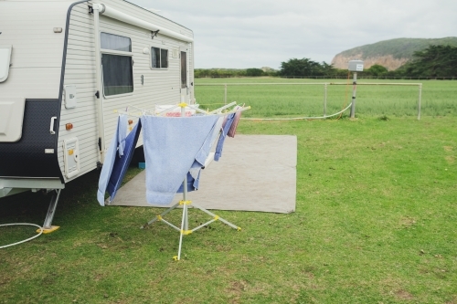 A caravan and clothes on racks - Australian Stock Image