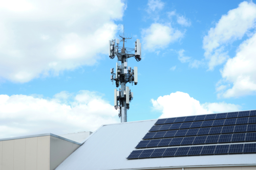 a cell tower with multiple antennas, transceivers, and other communication equipment. - Australian Stock Image