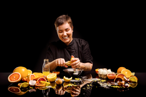 a chef making a citrus dessert - Australian Stock Image