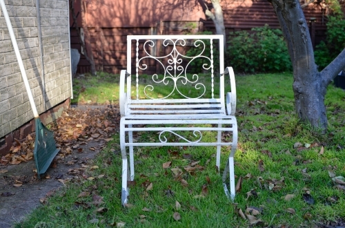 A classic metal garden chair painted white