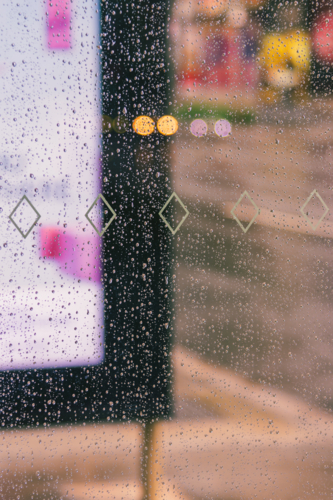 A Close up of Water Droplets on Glass on a Rainy Day - Australian Stock Image
