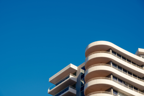 A closeup of an Apartment Building looking up from the footpath with Blue Sky - Australian Stock Image