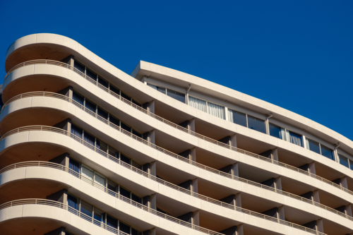 A closeup of an Apartment Building looking up from the footpath with Blue Sky - Australian Stock Image