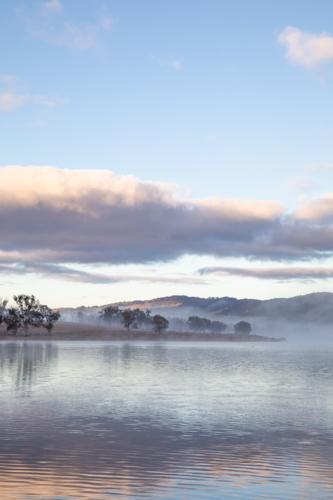 A cloudy sky over a country dam - Australian Stock Image